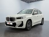 a white bmw x5 parked in a white room