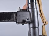 a close up of a machine gun with a sling attached to it