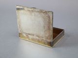 a silver box with a picture on it on a table