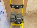 a yellow and black lawn mower sitting on the floor