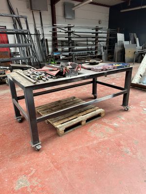 a workbench in a warehouse with a lot of tools on it