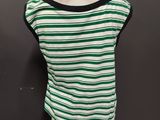 a green and white striped top on a mannequin dummy