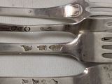 three forks that are sitting next to each other on a table