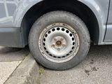 a car that has a flat tire on the side of the road