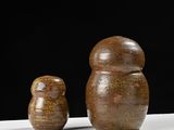 two brown vases sitting next to each other on a table