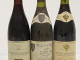 three bottles of wine are lined up on a white surface