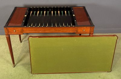 a wooden table with a game on it and a green chair