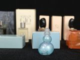 a lot of different perfume bottles on a table