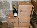 boxes of wine are stacked on top of each other in a room