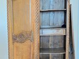 a wooden cabinet with a door open on a hard wood floor