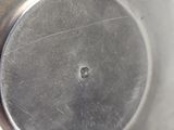 a metal bowl with a hole in the middle of it