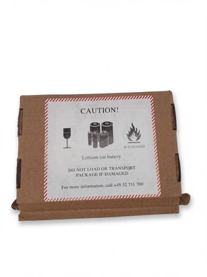 a cardboard box with a sign on it that says caution