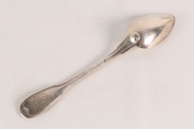a spoon that is sitting on a white surface