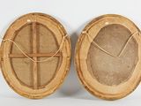 pair of round bamboo baskets with handles on white background
