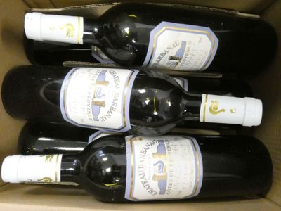 six bouteilles de vin dans une boîte en carton posée sur une table