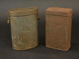 two old tins sitting next to each other on a table