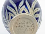 a blue and white vase that has writing on it