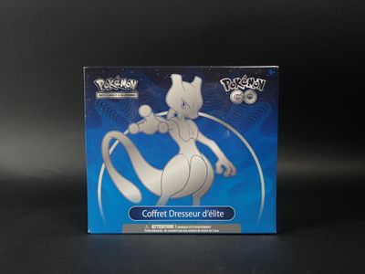 La boîte d'une figurine Pokémon est posée sur une surface noire.