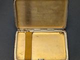 a small silver box with a yellow ribbon in it