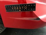 a sticker that says vauto on the front of a red car