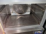 an open oven with a grill inside of it