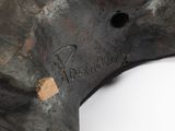 a close up of a metal object on a white surface