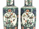 pair of chinese vases with birds and flowers painted on them