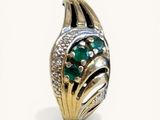 an image of a ring with a green stone surrounded by diamonds