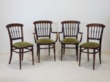 three chairs with green cushions and a white wall in the background