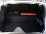 a white car with its trunk open and luggage in the trunk