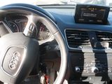 dashboard of a car with a steering wheel and dashboard controls