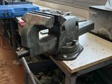 an old viset sitting on a workbench in a workshop