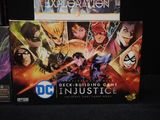 batman, superman, wonder, and justice board game in a display case