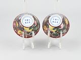 pair of chinese vases with floral designs on stands on a white surface