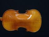 an antique violin on a black background with a black background