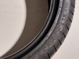 a close up of a tire on a white surface
