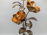 a close up of a lamp with flowers on a table
