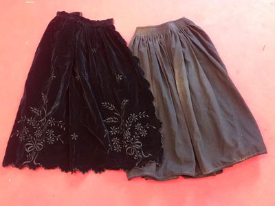 pair of black and grey skirts on a pink background