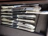 a bunch of knives in a case on the table