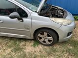 a small silver car with its hood open on the ground