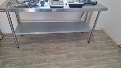 a stainless steel table with a lot of tools on top of it