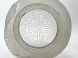 a clear glass bowl with a circular design on it