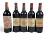 six bottles of wine are lined up in a row on a white surface