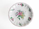 a white plate with pink and yellow flowers on it