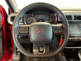 the interior of a car with a steering wheel and dashboard controls