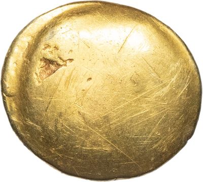 an old gold coin with a hole in the middle of it