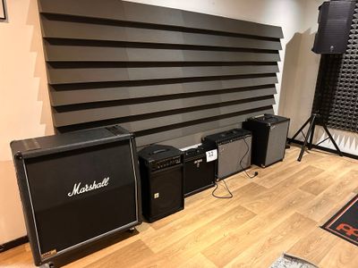 two amps and two speakers in a room