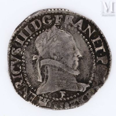 an old silver coin with a man ' s head on it