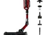 a close up of a cordless vacuum cleaner with a red handle