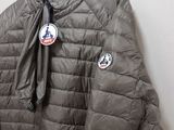 jacket hanging on a hanger on a wall in a room